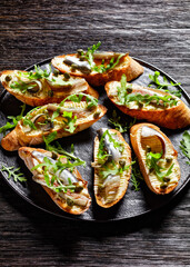 Fototapeta na wymiar anchovy butter sandwiches with capers and arugula