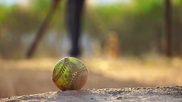 Softball ball with the practice of a male softball player