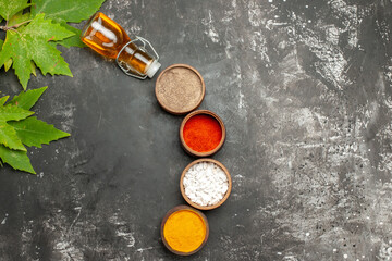 top view different seasonings with oil on dark background pepper spicy color