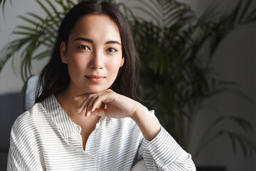 Home office concept. Young asian woman looking at camera with confident and professional face...