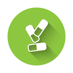 White Vitamin complex of pill capsule icon isolated with long shadow. Healthy lifestyle. Green circle button. Vector.