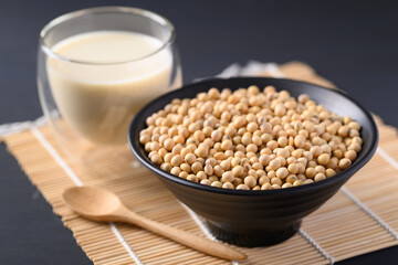 Soybeans seed in a black bowl and soy milk in a glass, Healthy food