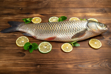front view fresh fish with lemon slices on the wooden desk sea meat ocean food