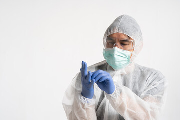 asian man preparing to wear a personal protective equipment suit in white background