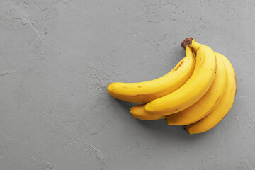 yellow ripe bananas on concrete gray background