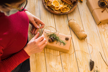 Woman is packing aroma craft box with rosemary