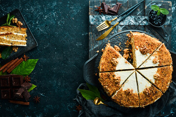 Delicious nut cake on a black stone plate. Top view. Rustic style.
