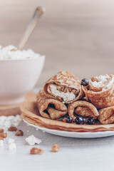 cottage cheese in a bowl and pancakes with curd filling