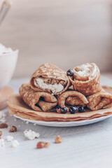 cottage cheese in a bowl and pancakes with curd filling