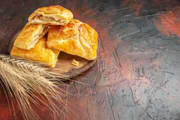 bottom view penovani khachapuri on wood board wheat spike on dark red background