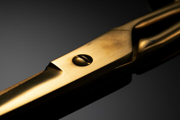Old scissors gold color on gray gradient background