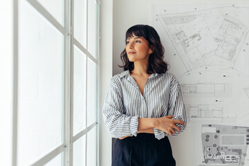 Portrait of woman entrepreneur at office - obrazy, fototapety, plakaty
