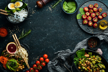 Assortment of food on black stone background. Buddha bowl. Top view. Free space for your text.