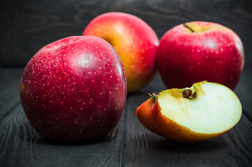 Red apples and half on black vintage boards. Idea for following the apple diet.
