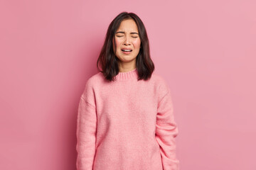 Portrait of unhappy brunette woman feels despair cries unhappily faces some problems has broken...