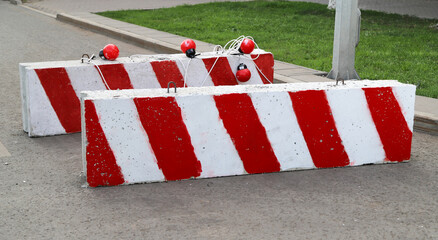 Two white and red concrete road blocks during road reconstruction