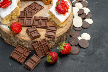 top view cake slices with cookies and chocolate bars on a dark background pie sweet fruit