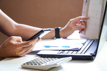 Close up of man busy paying bills online on computer calculating household finances or taxes on...