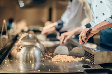 Hand of man take cooking of meat with vegetable grill, Chef cooking wagyu beef in Japanese teppanyaki restaurant