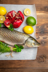 top view fresh fish with lemons and greens on the brown desk ocean food sea seafood