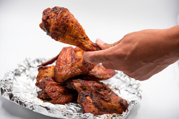 Hand hold grill chicken for meal.