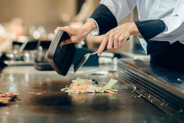 Hand of man take cooking of meat with vegetable grill, Chef cooking wagyu beef in Japanese teppanyaki restaurant