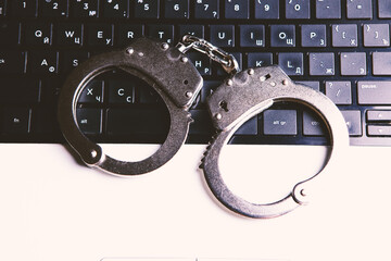 handcuff with laptop on the table