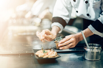 Hand of man take cooking of meat with vegetable grill, Chef cooking wagyu beef in Japanese teppanyaki restaurant