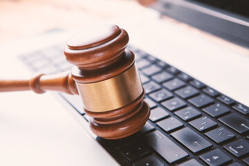 Close up view of a hammer and a computer keyboard.