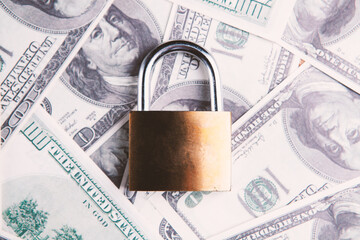 Padlock on the dollar bills. Close up. Business concept.