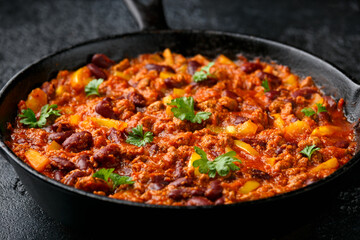 Vegetarian vegan mince chili con carne served in cast iron skillet pan