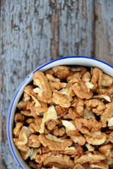 Walnut kernels in cup organic tree harvest blue wood texture 1