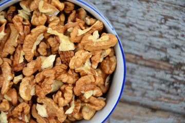 Walnut kernels in cup organic tree harvest blue wood texture 2