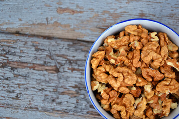 Walnut kernels in cup organic tree harvest blue wood texture 4