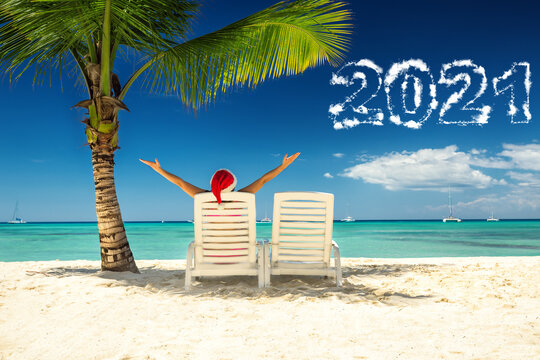 2021 New Year Concept With Woman In Santa's Hat  Relaxing On Tropical Beach