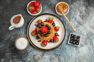 top view yummy pancakes with fresh fruits on light background fruits cake sweet