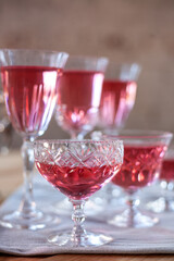 crystal glasses with rose wine on a wooden table. Wedding decoration