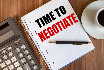 TIME TO NEGOTIATE written in a white notepad near a calculator and a cup of coffee on a dark wooden background