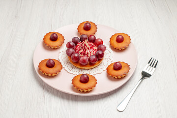 front view delicious cakes with grapes on white background biscuits pie dessert