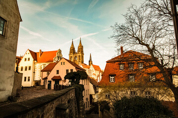 Naklejka premium Meissen,Saxony, Germany. 17.02. 2019, .pedestrian old German street at sunset. cobblestone pavement, .ancient gothic church