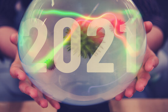 Crystal Ball Divination About The Future Of The Coronavirus In 2021. Magic Ball In The New Year With The Flu Virus In The Hands Of A Fortune Teller