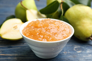 Tasty homemade pear jam and fresh fruits on blue wooden table