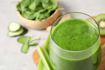 Delicious fresh green juice in glass, closeup. Space for text
