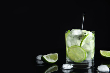 Delicious mojito and ingredients on black background. Space for text