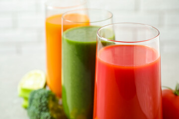 Different tasty juices in glasses, closeup. Space for text