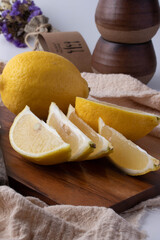 Yellow lemon on a wooden cutting board