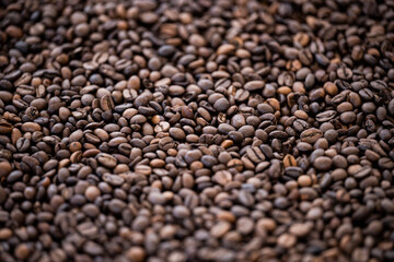 Flat lay with copy space, close-up view of some roasted coffee beans forming a natural pattern. Natural background.