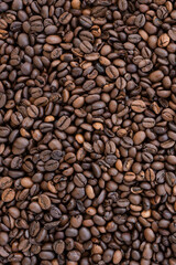 Flat lay with copy space, close-up view of some roasted coffee beans forming a natural pattern. Natural background.