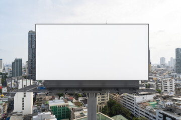 Obraz premium Blank white road billboard with Bangkok cityscape background at day time. Street advertising poster, mock up, 3D rendering. Front view. The concept of marketing communication to promote or sell idea.