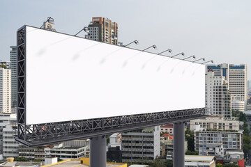 Blank white road billboard with Bangkok cityscape background at day time. Street advertising poster, mock up, 3D rendering. Side view. The concept of marketing communication to promote or sell idea.